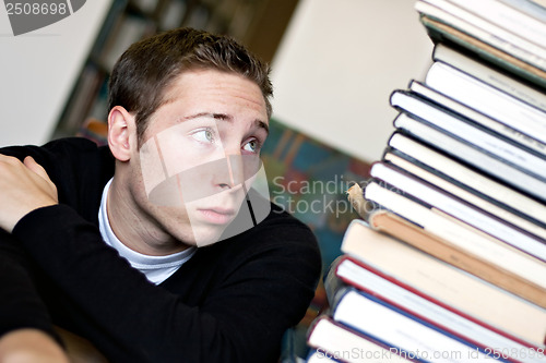 Image of Worried Student Looking At Books