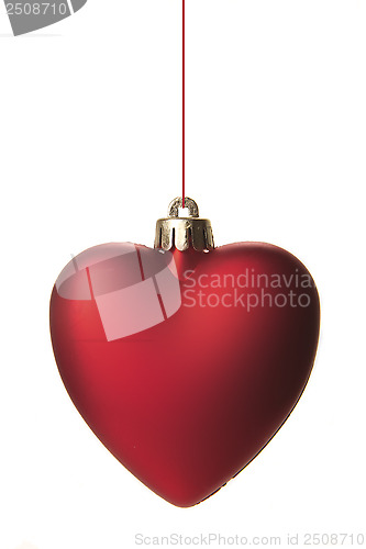 Image of red christmas ball as heart hanging isolated