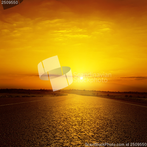 Image of sunset over asphalt road