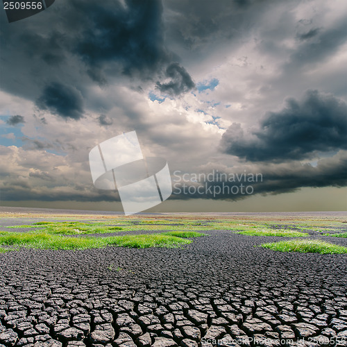 Image of darken dramatic sky over cracked earth