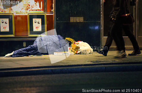 Image of Homeless man sleeping on the street