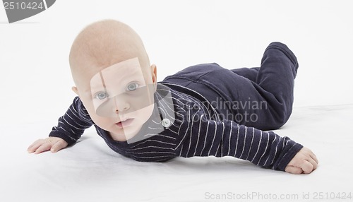 Image of cheerful baby trying to get around