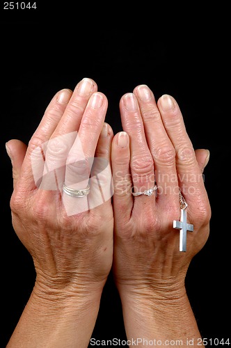 Image of Hands, rings and cross