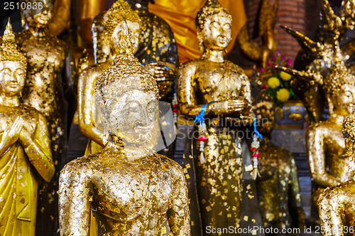 Image of Golden foil on buddha statue