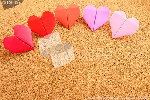 Image of Origami colorful heart on corkboard