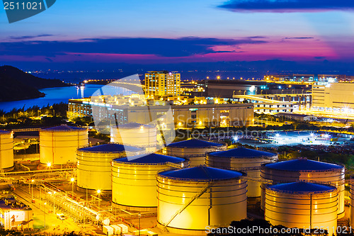 Image of Oil tanks plant during sunset