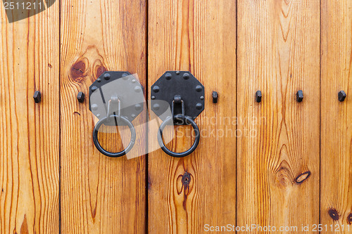 Image of Metallic door knob with wooden door