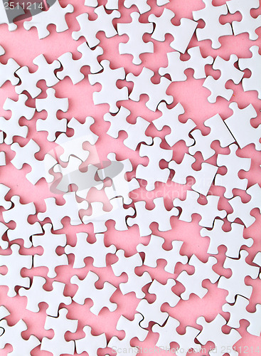 Image of White puzzle on pink background
