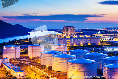 Image of Oil tanks for cargo service during sunset