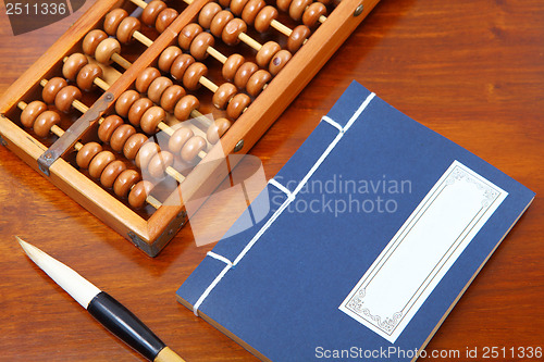 Image of chinese book , abacus and writing brush