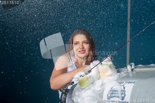 Image of Sexy woman washing car