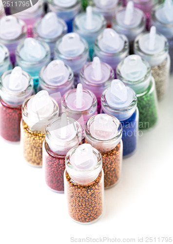 Image of Small Glass Jars filled with Balls of Bead