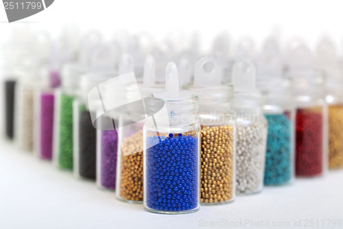 Image of Small Glass Jars filled with Balls of Bead