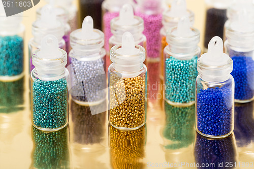 Image of Small Glass Jars filled with Balls of Bead