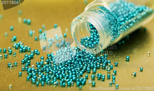 Image of Small Glass Jar filled with Green Balls of Bead