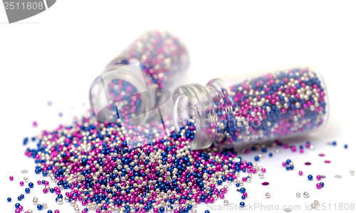 Image of Small Glass Jars filled with Multicolored Balls of Bead