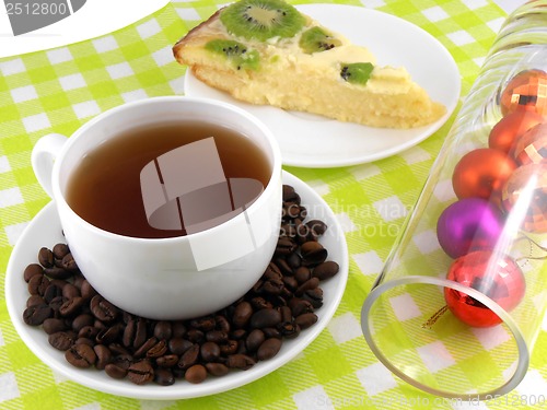 Image of Christmas decoration with cup of coffee, coffee beans and sweet kiwi cake