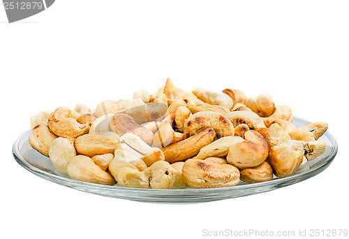 Image of Saucer with roasted cashew nuts isolated on white background