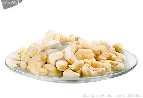 Image of Saucer with a row cashew nuts isolated on white background