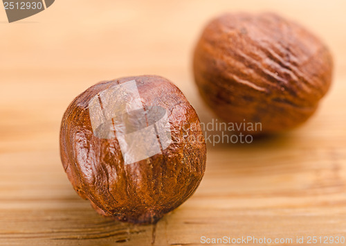 Image of A pile of shell-less hazelnuts, isolated on textural wood backgr