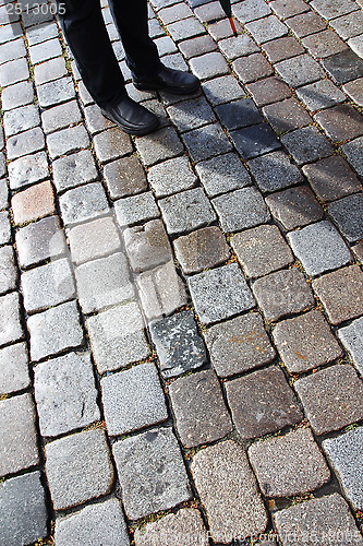 Image of Man, shadow and coblestones