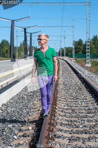 Image of Handsome man on train tracks