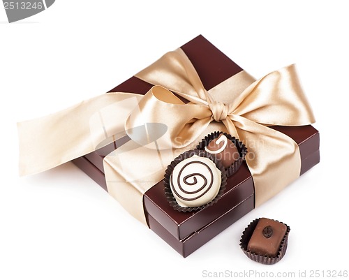 Image of brown box with candies and golden tape