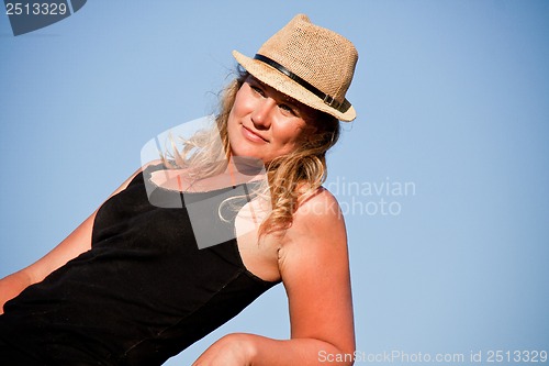 Image of young woman training horse outside in summer