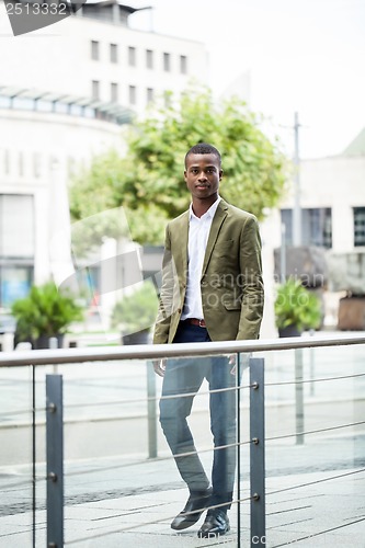 Image of young successful african business man outdoor in summer