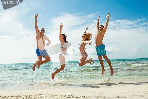 Image of young happy friends havin fun on the beach