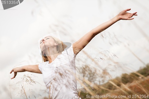 Image of young happy attractive woman arms wide open 