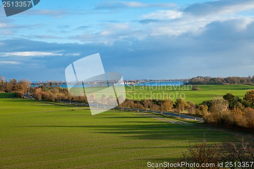 Image of beautiful landscape in autum baltic see green field blue sky
