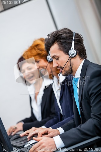 Image of friendly callcenter agent operator with headset telephone 