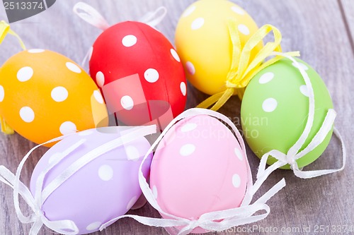 Image of colorful easter egg decoration on wooden background