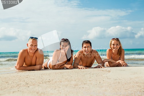 Image of young happy friends havin fun on the beach