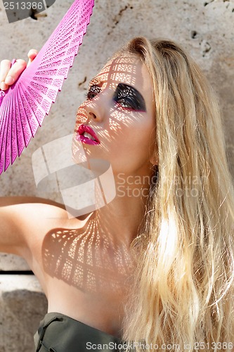 Image of young beautiful woman with smokey eyes and pink lips