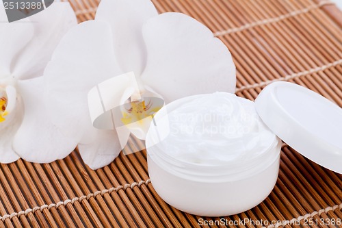 Image of cosmetic face cream on wooden background 