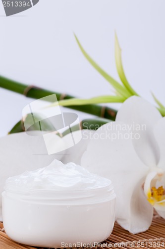 Image of cosmetic face cream on wooden background 