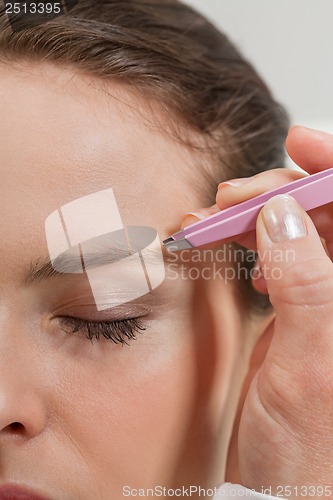 Image of young beautiful woman eyebrow plucking tweezers eyes hair 