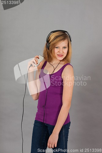 Image of dancing happy teenager girl listening to music 