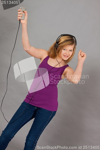 Image of dancing happy teenager girl listening to music 