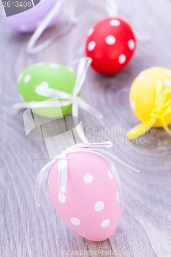 Image of colorful easter egg decoration on wooden background