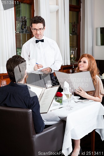 Image of man and woman for dinner in restaurant