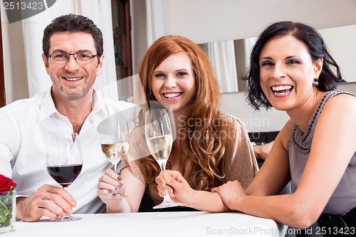 Image of smiling happy people in restaurant