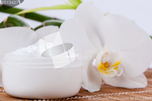 Image of cosmetic face cream on wooden background 