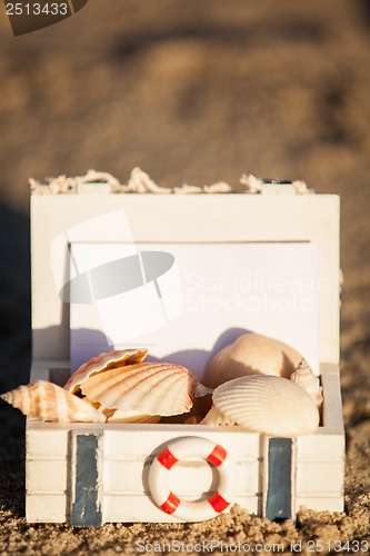 Image of sailing boat and seashell in sand decoration closeup