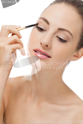 Image of doing the makeup brown eyeshadow on beautiful eyes