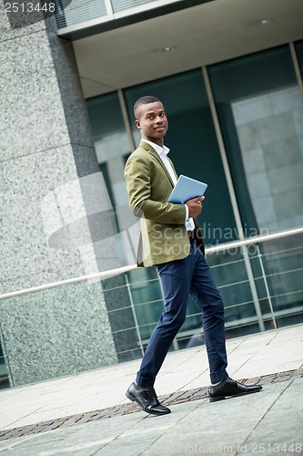 Image of young successful african business man outdoor in summer