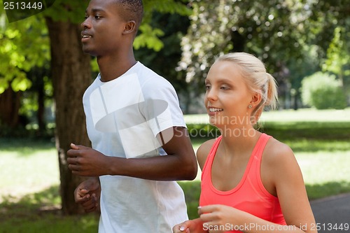 Image of young couple runner jogger in park outdoor summer