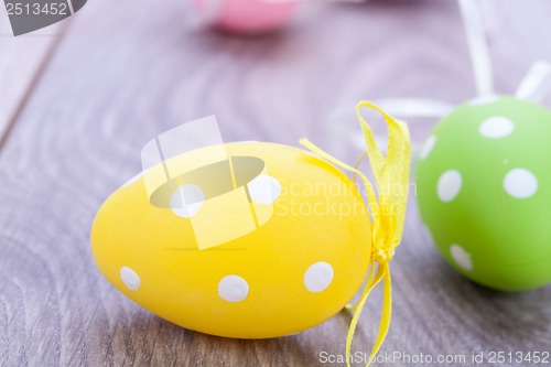 Image of colorful easter egg decoration on wooden background